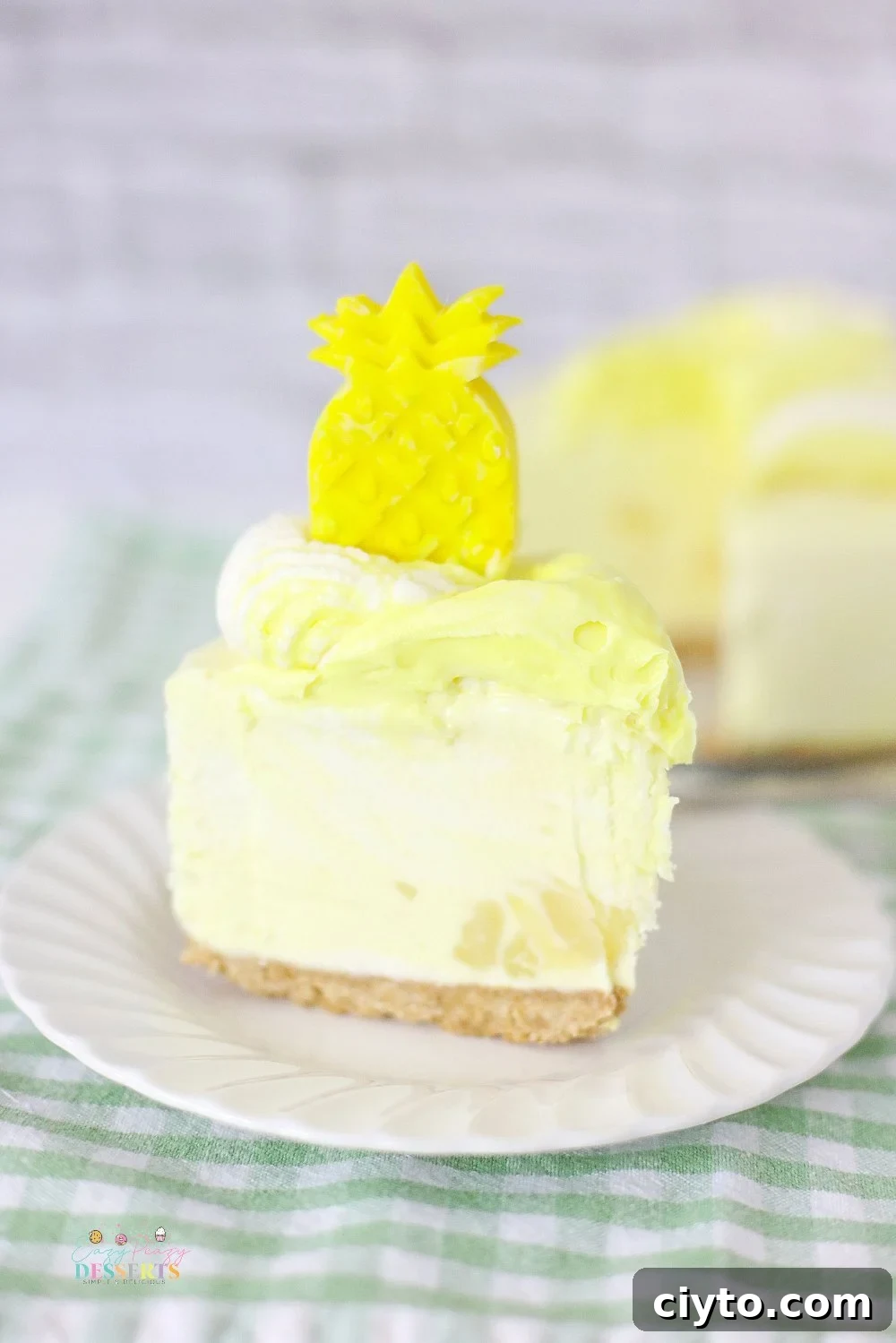 Creamy Pineapple Whip Cheesecake Recipe 2 A slice of pineapple cheesecake on a white dessert plate