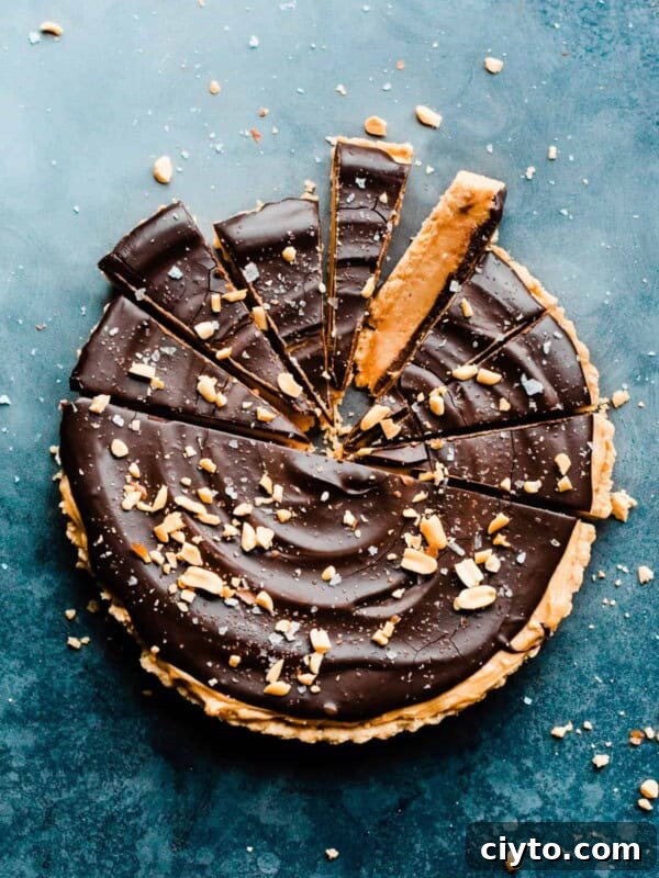 The sliced peanut butter tart on a blue surface.