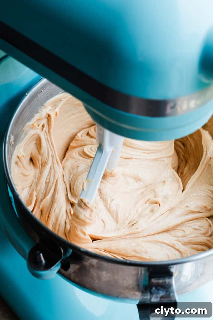 Peanut butter cheesecake batter in a stand mixer.