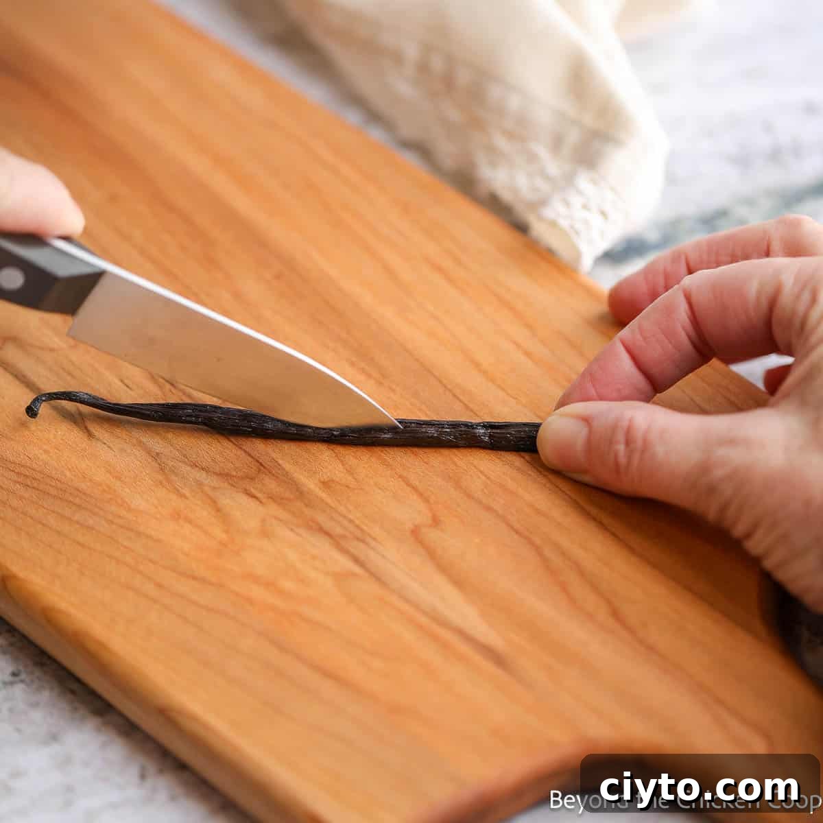 Slicing a vanilla bean in half lengthwise.