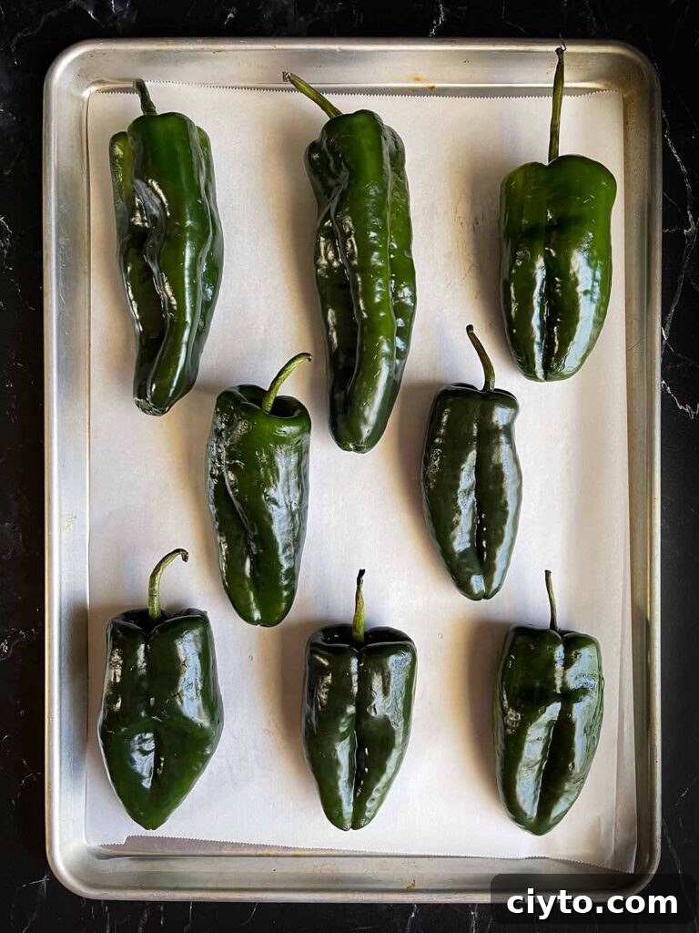Poblano peppers on a baking sheet.