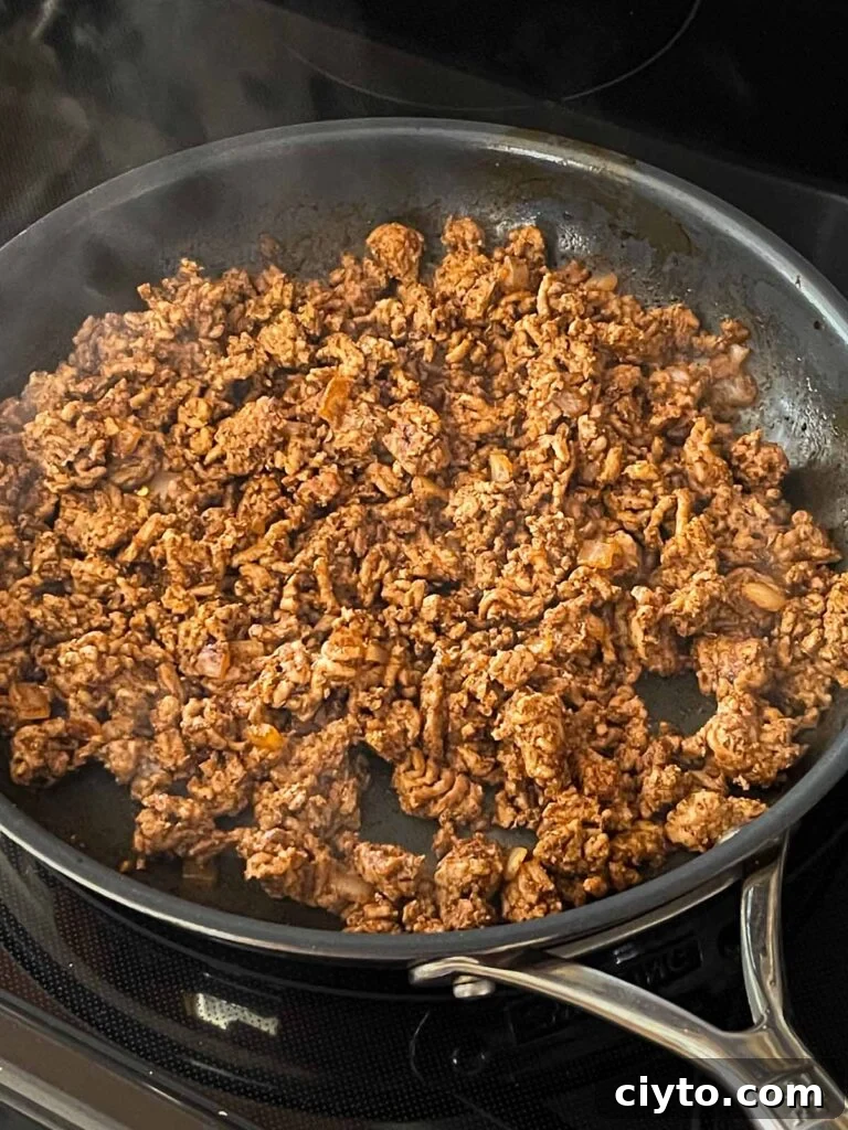 Seasoned ground beef in a skillet.
