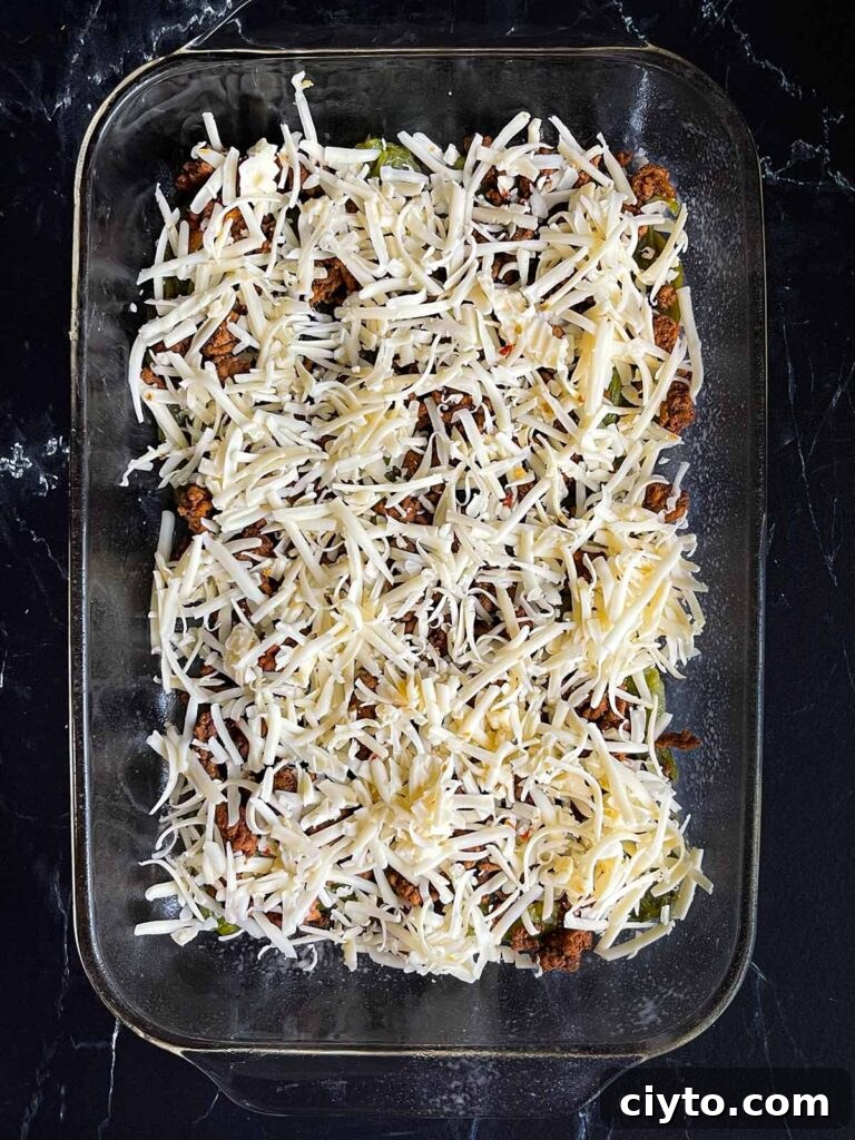 One layer of chile relleno casserole in glass baking dish.