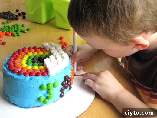 Mini Rainbow Layer Cake Recipe for Birthday Parties 4 child decorating cardboard cake plate with markers