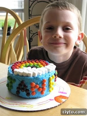 Mini Rainbow Layer Cake Recipe for Birthday Parties 5 child with finished rainbow skittle cake