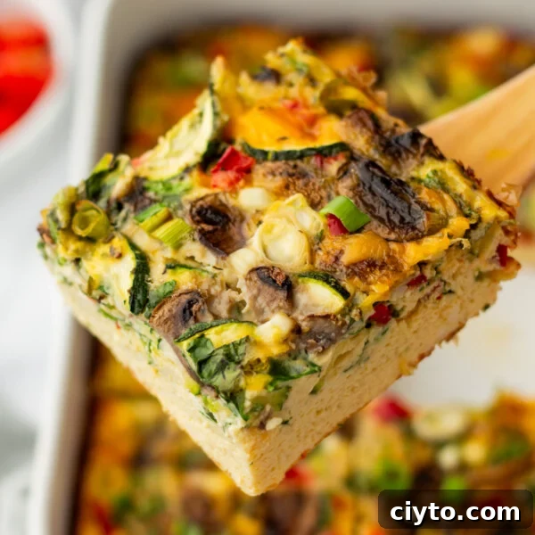 A close up image of a slice cottage cheese egg bake.