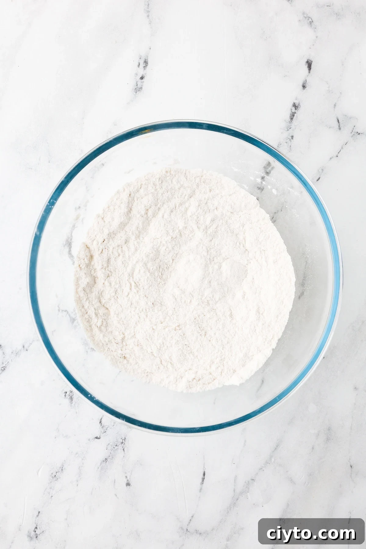 An overhead image of combining the dry ingredient mixture together in a bowl.