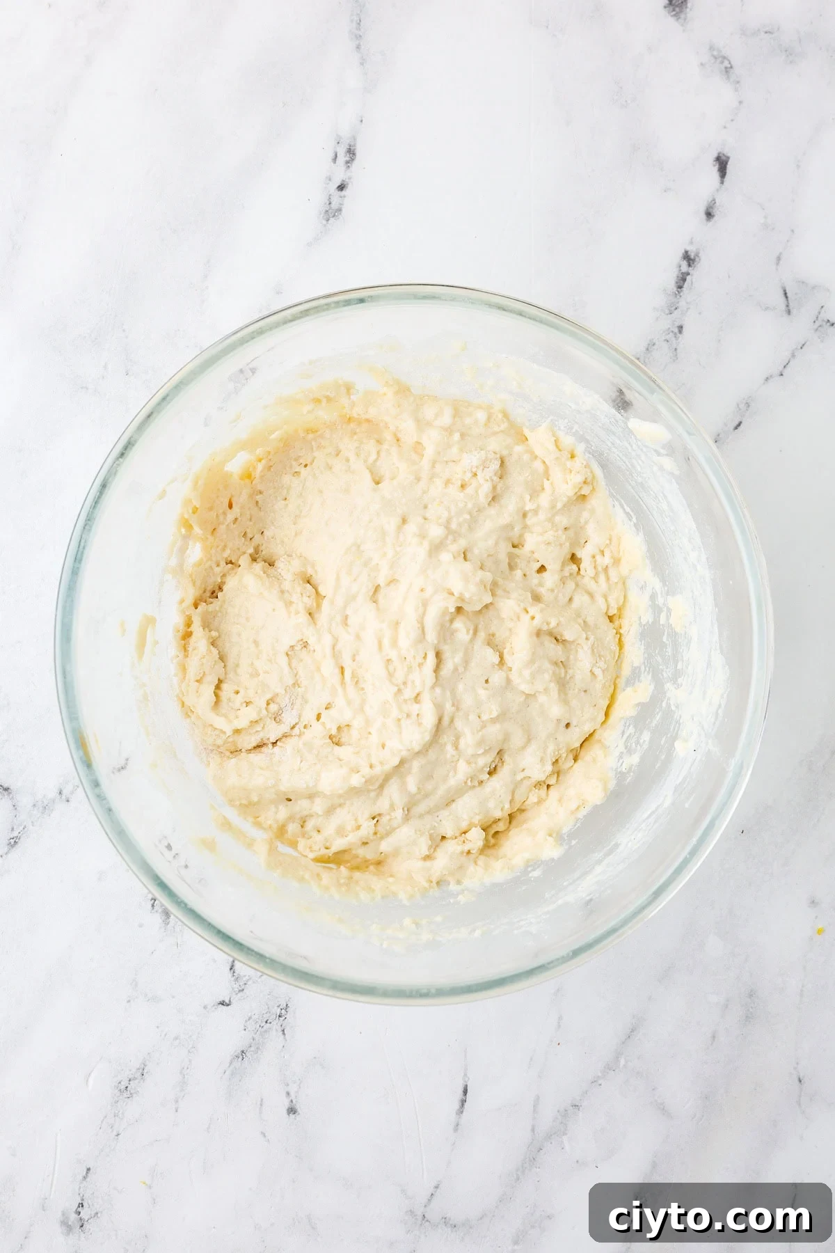 An overhead image of combining the wet and dry ingredient mixture in a bowl.