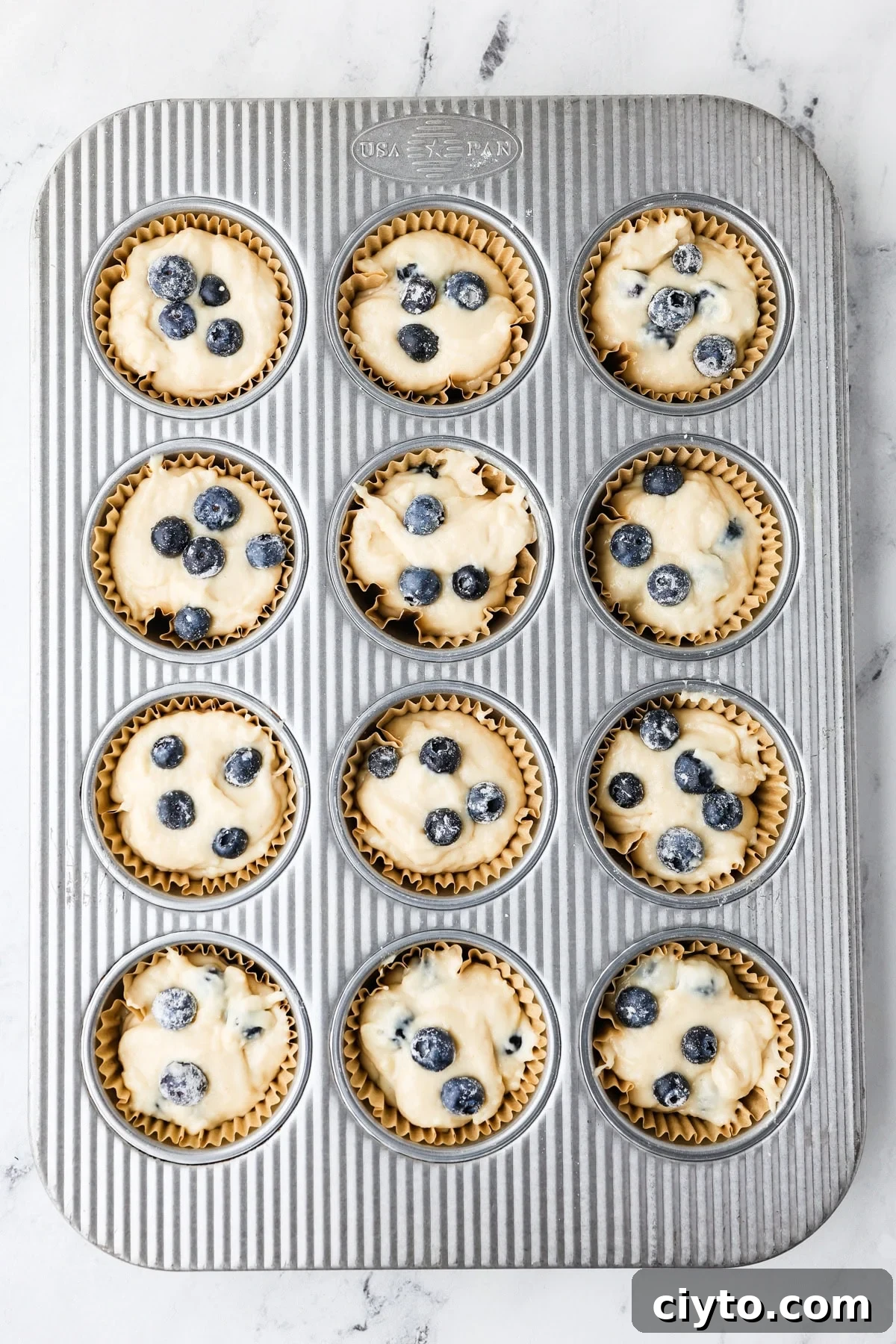 An overhead image of transferring the mixture in a muffin tin.