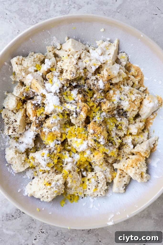 Tofu in bowl with seasonings.