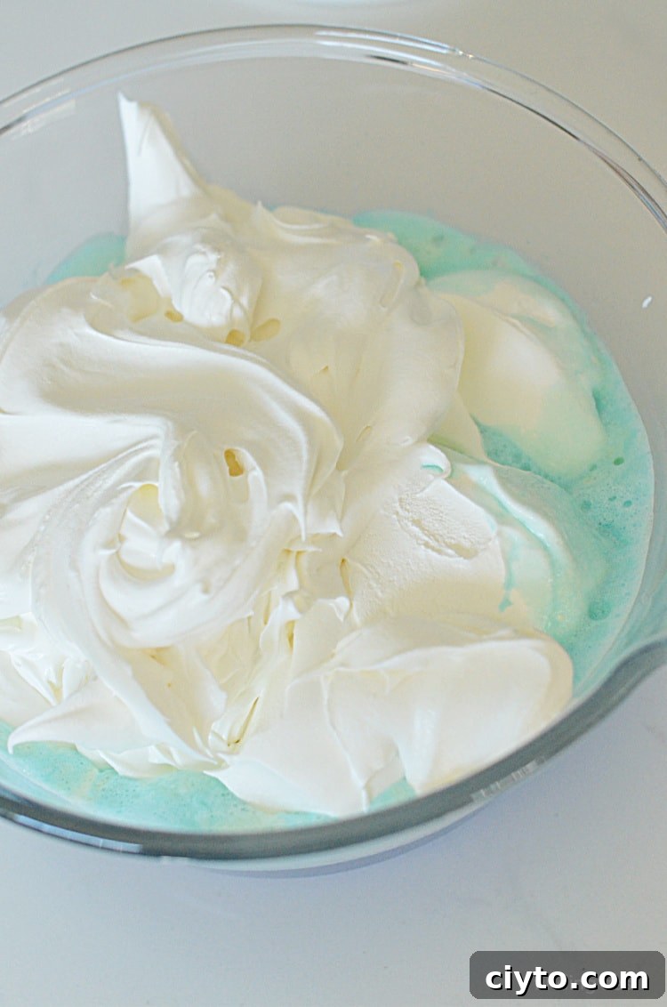 Adding whipped topping to Jello for Jello Magic Mousse