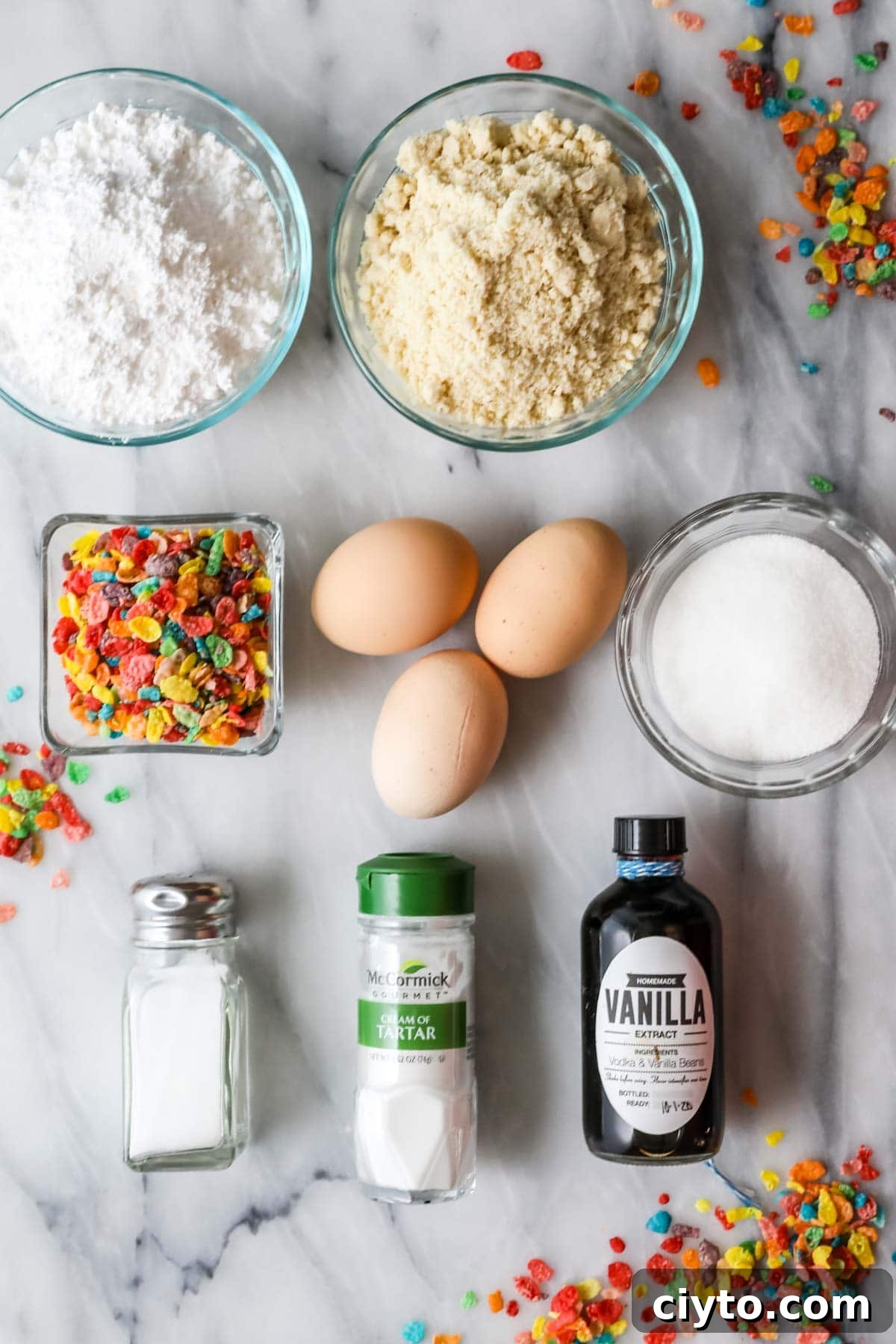 Overhead view of ingredients including fruity pebbles, almond flour, eggs, and more.