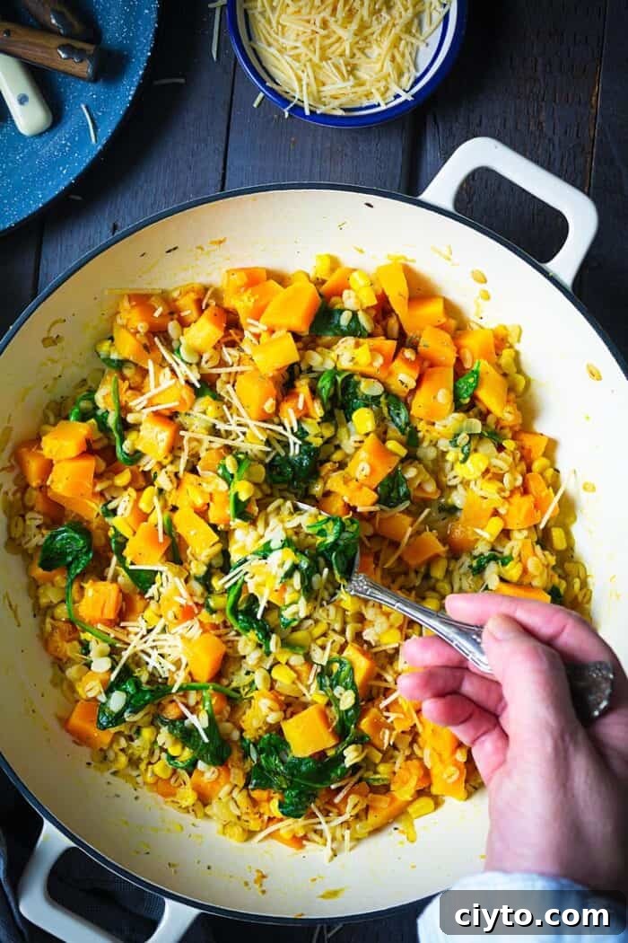 Creamy Butternut Squash Barley Risotto with Spinach and Corn 5 Serving the dish with a spoon.