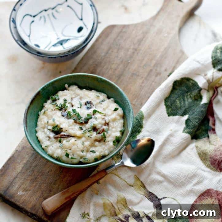 a photo of Creamy No Stir Parmesan Mushroom Risotto overhead and at a distance with a towel and spoon and bowls in the frame