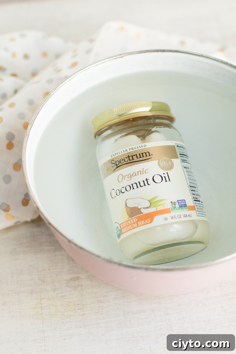 liquefy coconut oil by submerging the jar in a bowl of hot water