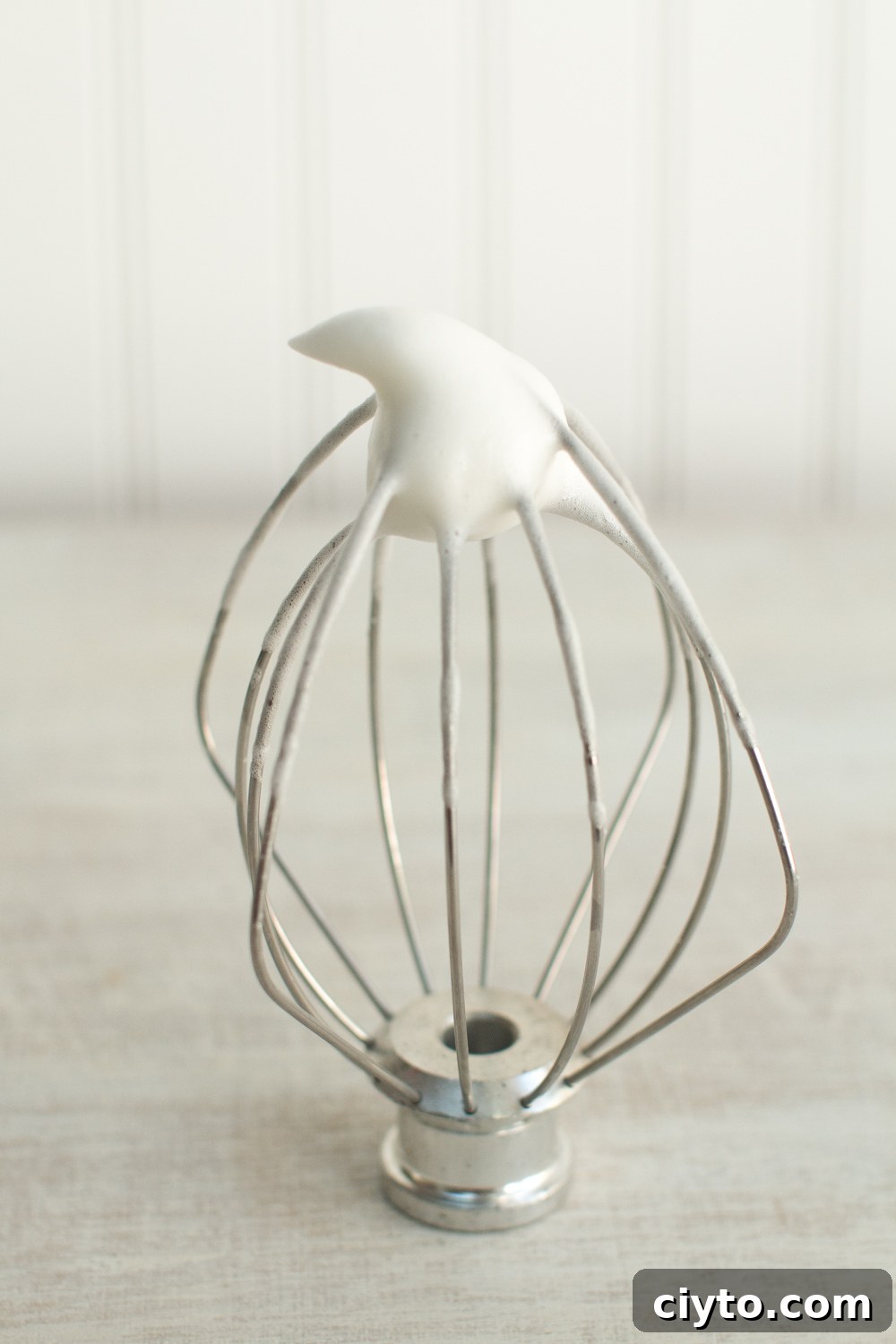 egg whites and sugar whisked together forms an airy mix that stands up at the tip of the whisk in a soft peak when placed upside down