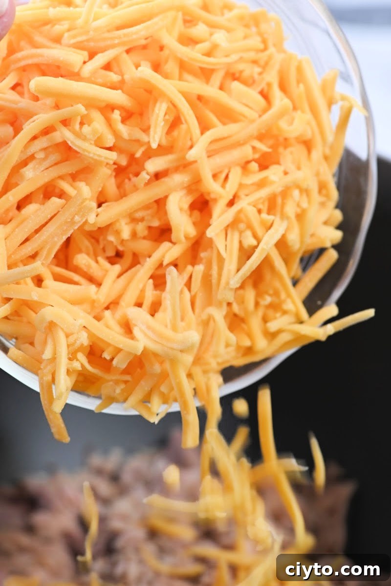 Adding shredded cheddar cheese