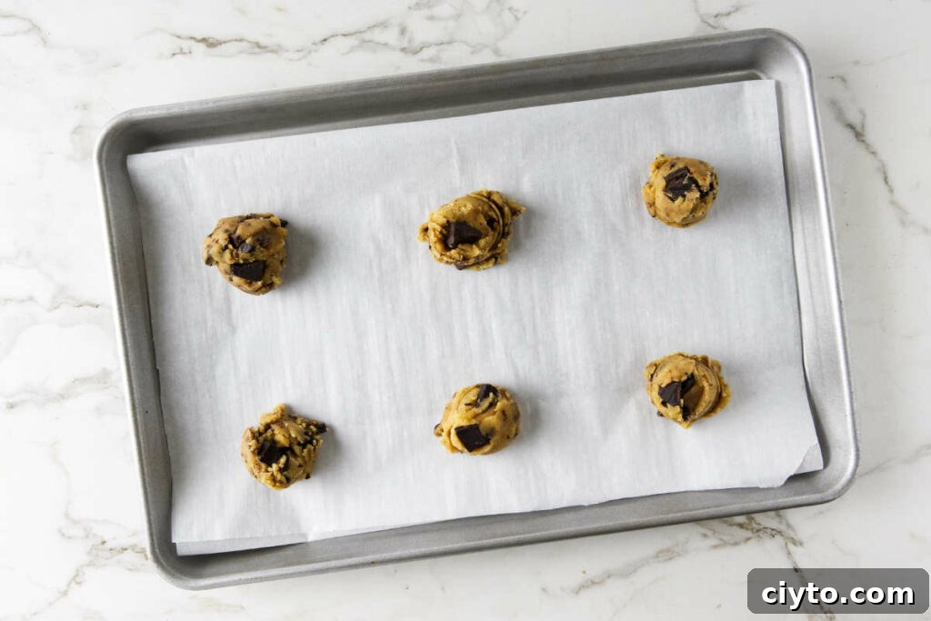 Egg Yolk Cookies Recipe: Crispy, Buttery Treats 8 Placing cookie dough on a baking sheet.