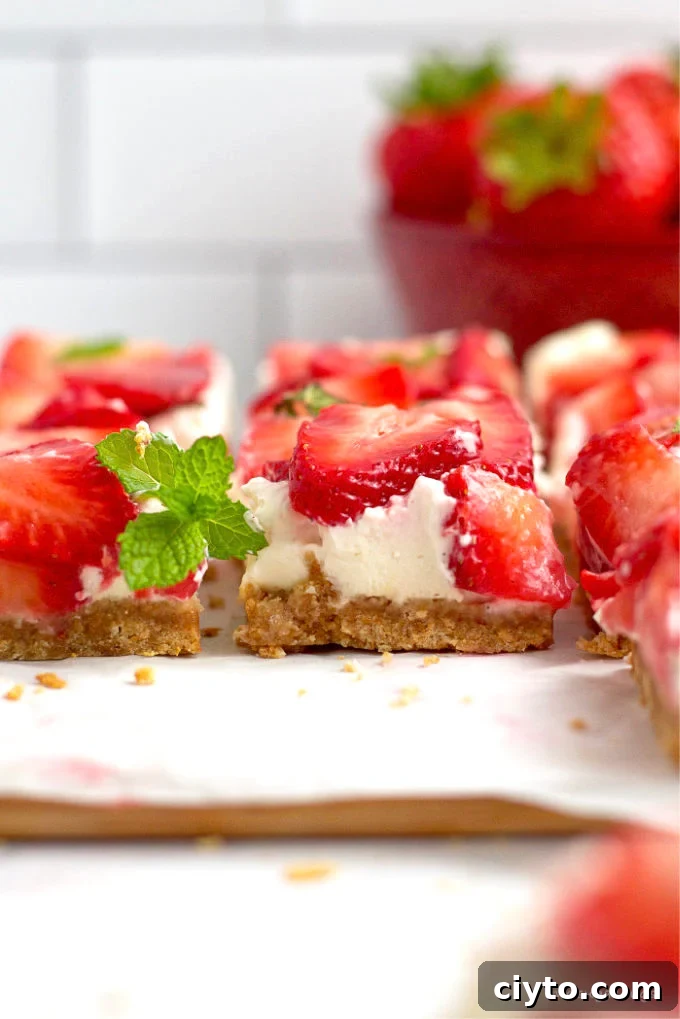 no bake mascarpone cheesecake bars on a parchment lined cutting board