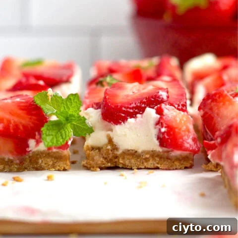 no bake mascarpone cheesecake bars on a parchment lined cutting board