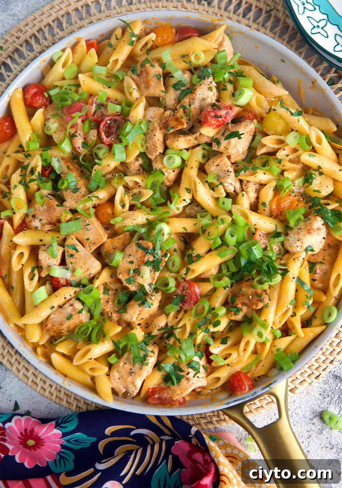 Cajun Chicken Pasta in a white skillet with a gold handle.