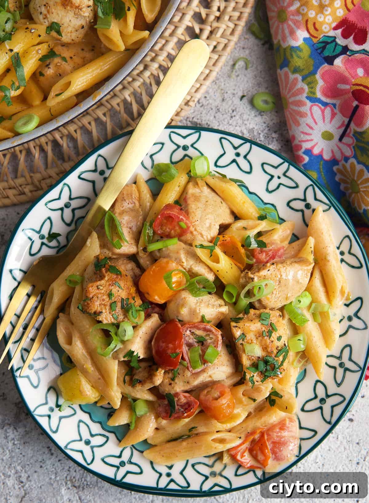 Cajun Chicken Pasta on a plate with a gold fork