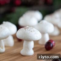 Meringue mushrooms topped with cocoa powder.