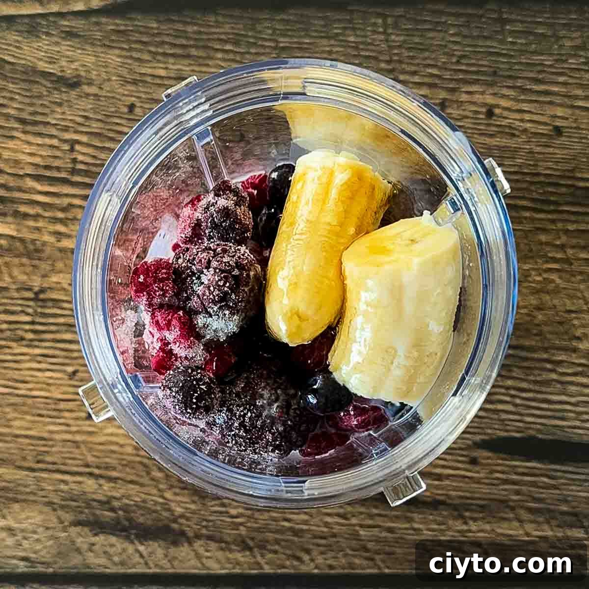 The ingredient for the smoothie in a blender.