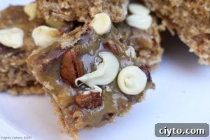 Caramel Pecan Oat Slice is a chewy oat slice studded with chocolate chips and topped with caramel, coconut, pecans and white chocolate. #caramelslice #carameloatbars #pecanoatbars #caramelpecanoatbars #pecancaramel #oatslice #oatmealbars