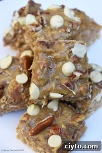 Caramel Pecan Oat Slice is a chewy oat slice studded with chocolate chips and topped with caramel, coconut, pecans and white chocolate. #caramelslice #carameloatbars #pecanoatbars #caramelpecanoatbars #pecancaramel #oatslice #oatmealbars