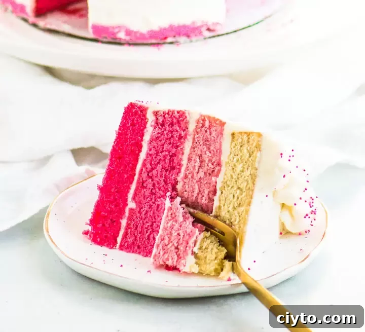 Pink Ombre Cake Recipe: Step-by-Step for Gorgeous Layers 6 slice of pink ombre cake on a plate with a fork taking a bite out of it