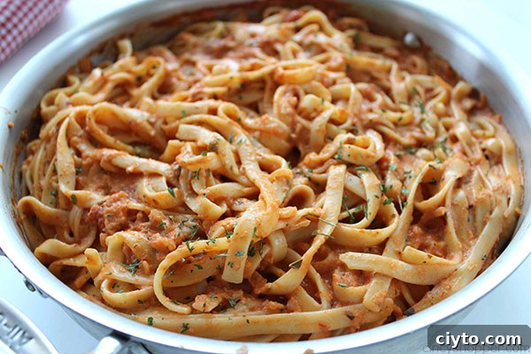 Creamy Tomato Fettuccine - perfect for a dinner side dish or even a meal. The pasta dish is creamy, full of flavor, and so easy to make. My family LOVES it!