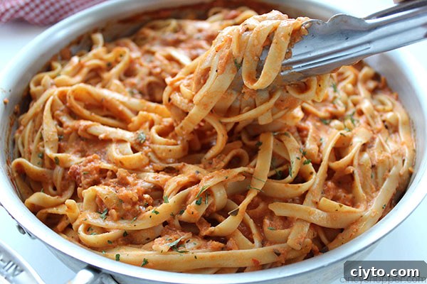 Creamy Tomato Fettuccine - perfect for a dinner side dish or even a meal. The pasta dish is creamy, full of flavor, and so easy to make. My family LOVES it!
