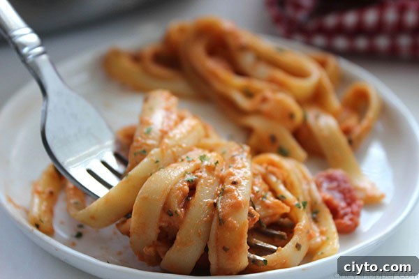 Creamy Tomato Fettuccine - perfect for a dinner side dish or even a meal. The pasta dish is creamy, full of flavor, and so easy to make. My family LOVES it!