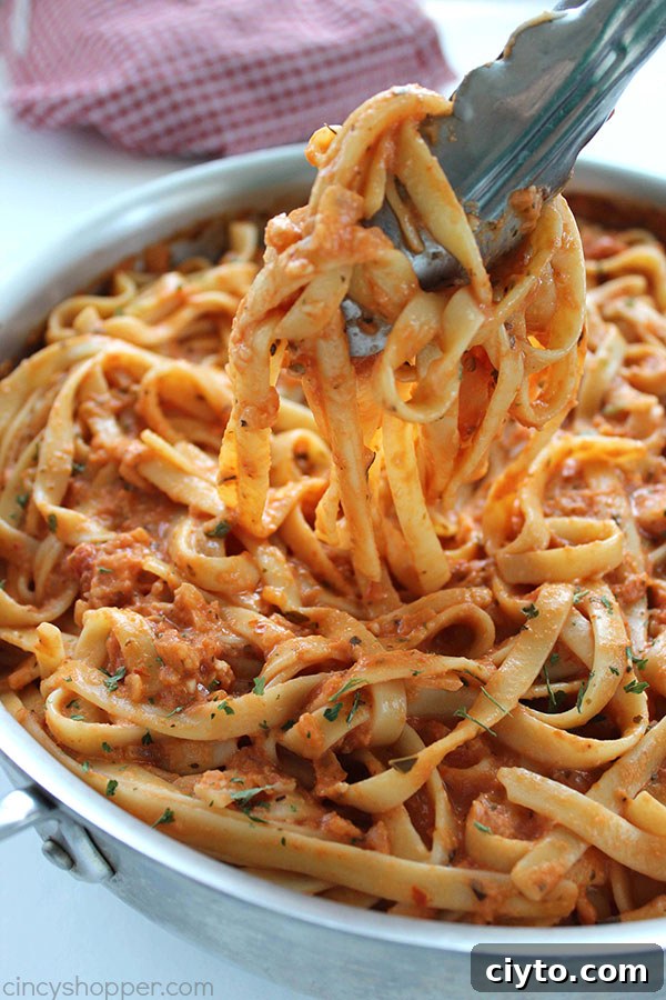 Creamy Tomato Fettuccine - perfect for a dinner side dish or even a meal. The pasta dish is creamy, full of flavor, and so easy to make. My family LOVES it!