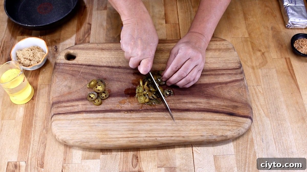 dicing jalapenos on a cutting board