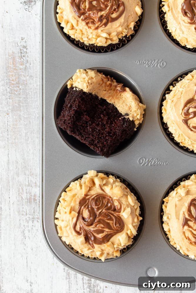 A muffin pan with chocolate peanut butter cupcakes.