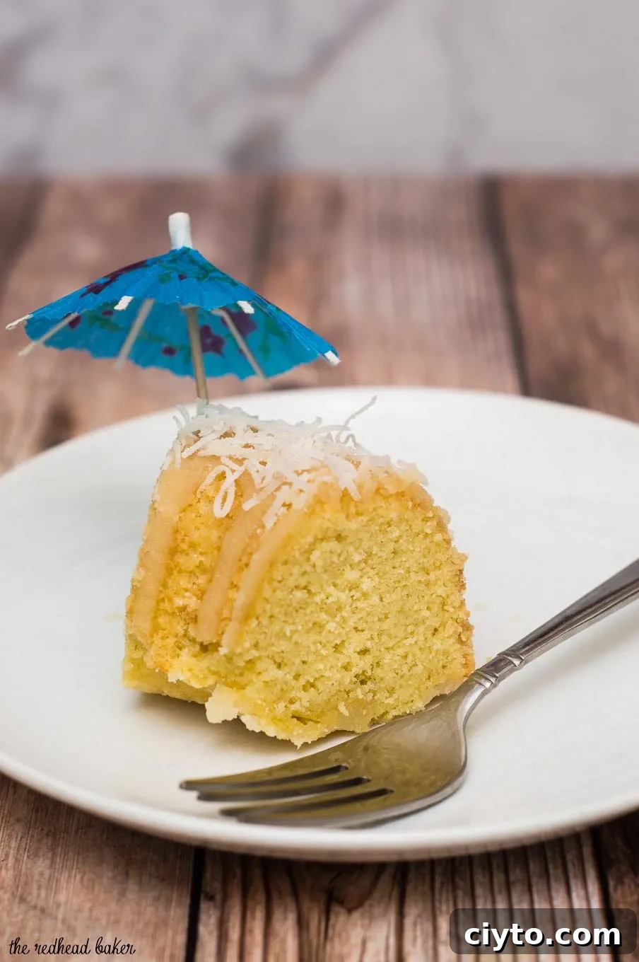 Slice of Bahamian rum cake served with toasted coconut