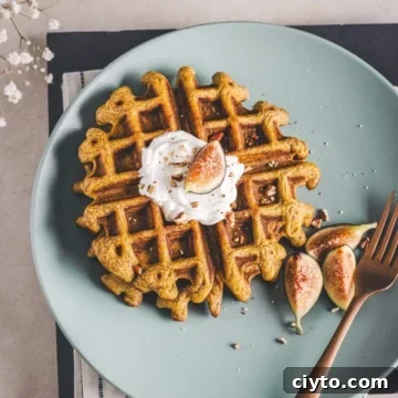 pecan pumpkin waffles on a green serving plate.