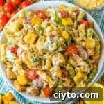 Chicken Caesar Pasta Salad Recipe with Crispy Croutons 10 Chicken Caesar Pasta Salad with lettuce, tomatoes, Parmesan cheese, croutons, and caesar salad dressing.