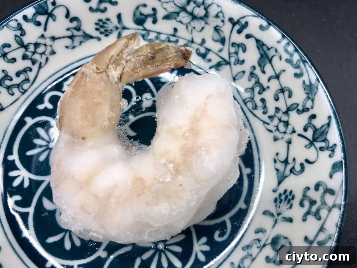 Frozen, raw, peeled, deveined, tail-on shrimp.