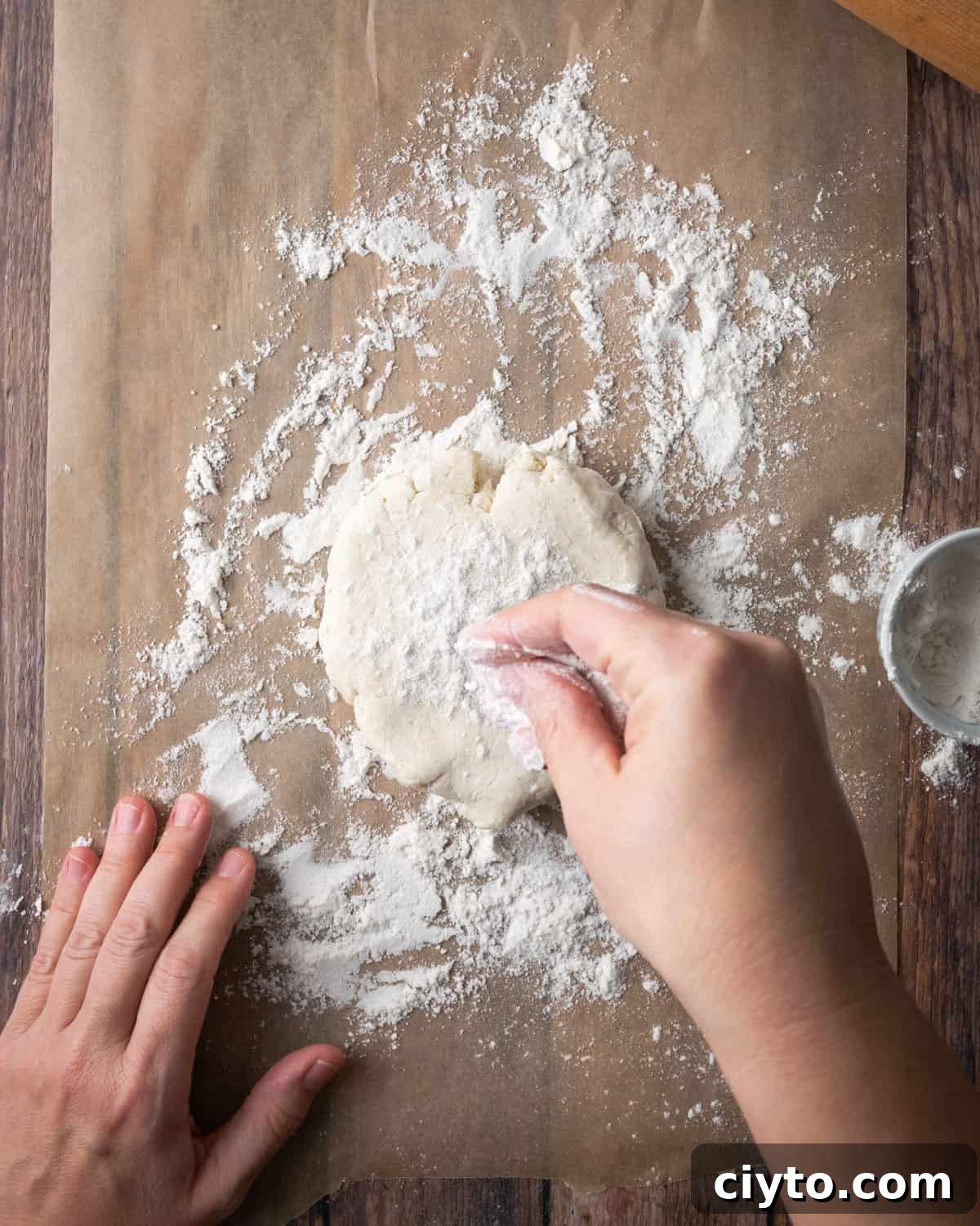 How to Make a Flaky Gluten-Free Pie Crust 17 A disc of pie dough on a floured piece of parchment paper.