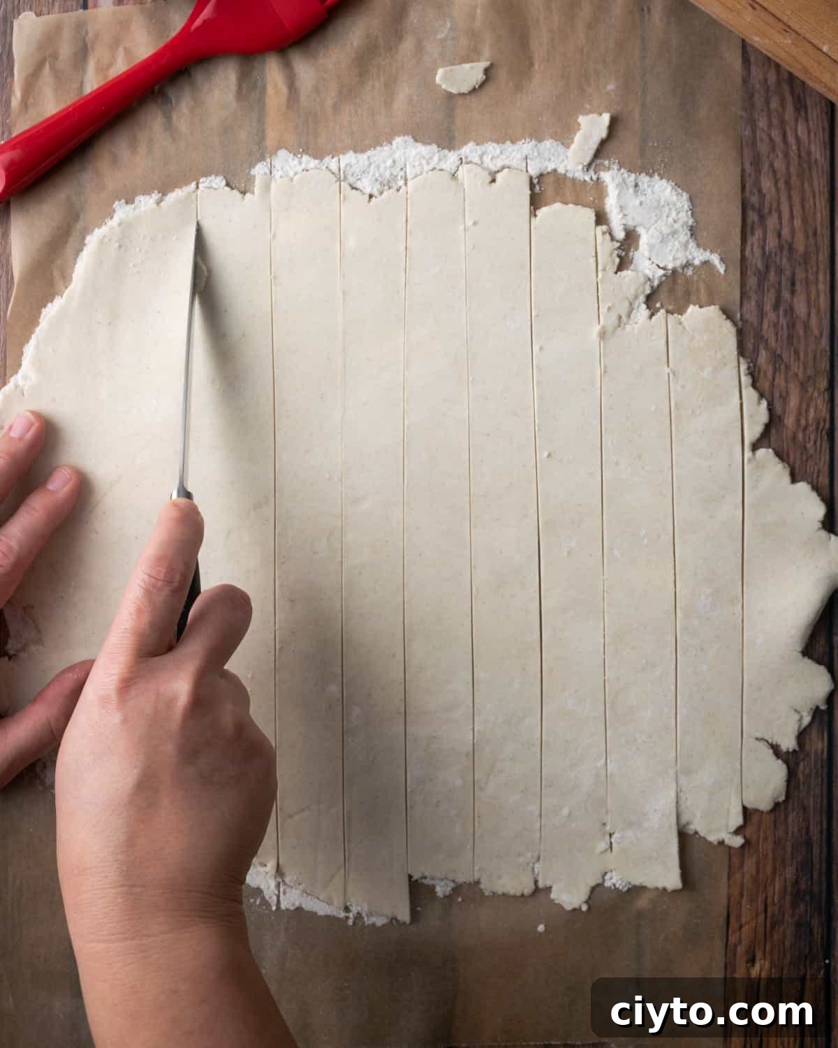 How to Make a Flaky Gluten-Free Pie Crust 21 A sheet of pie dough being cut into strips.