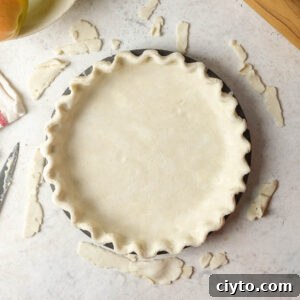 An unbaked pie crust in a pie tin.