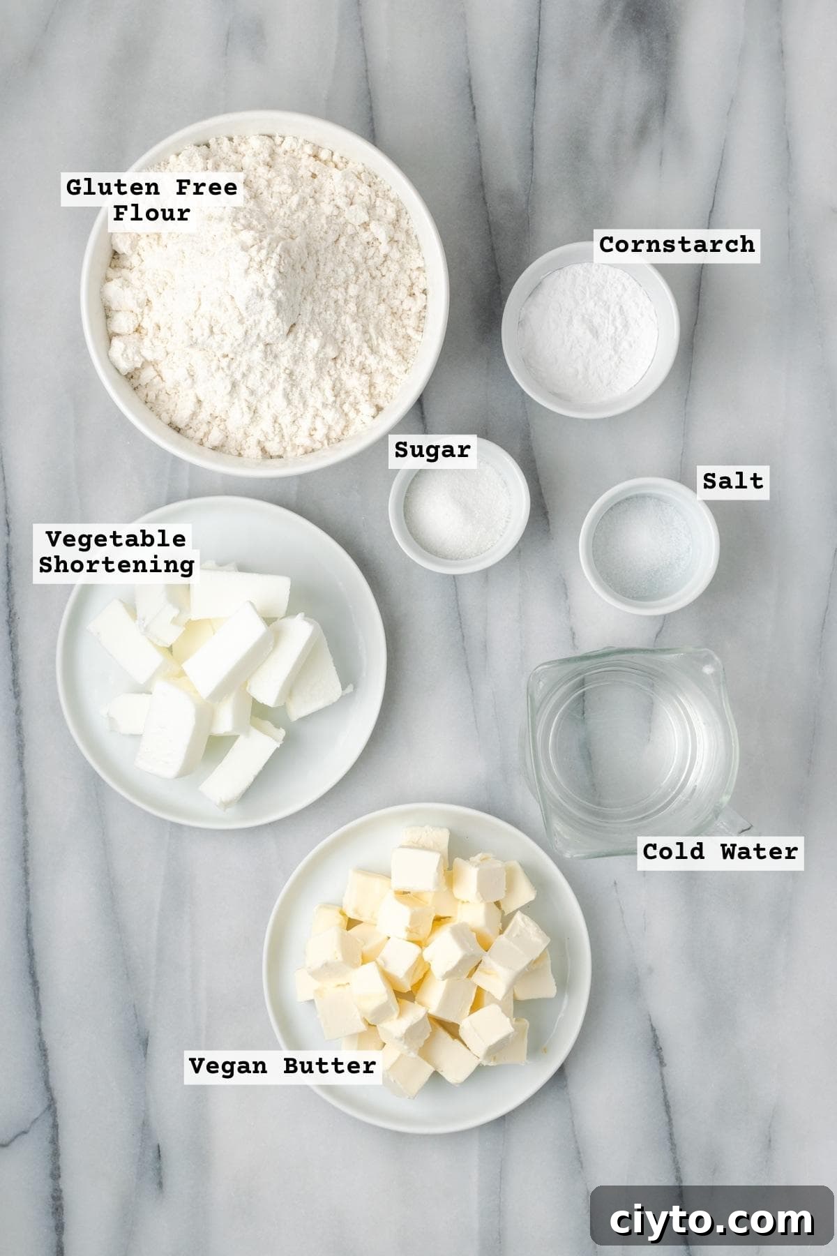 How to Make a Flaky Gluten-Free Pie Crust 6 Ingredients for gluten free pie crust on a white marble table.
