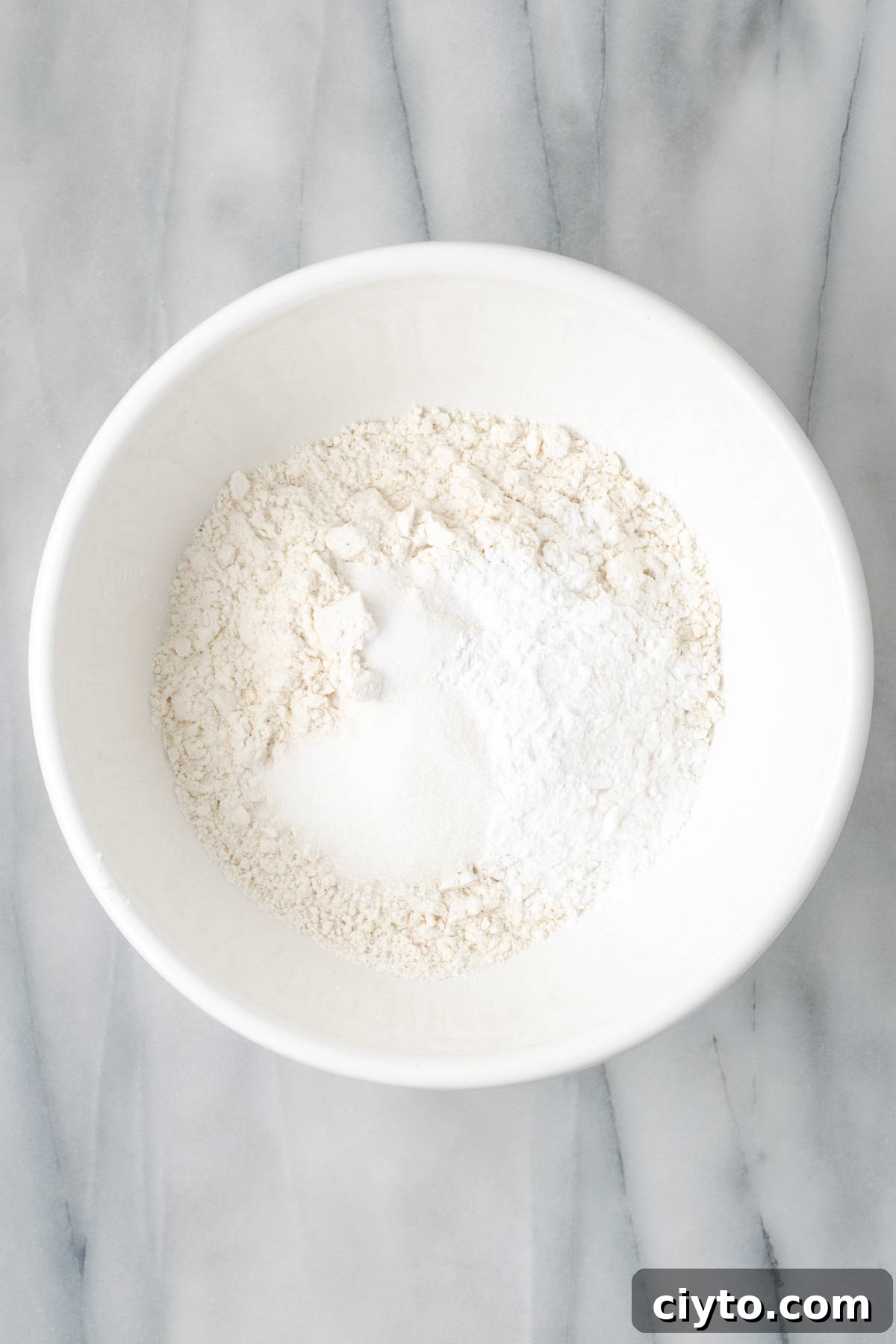 How to Make a Flaky Gluten-Free Pie Crust 8 Gluten free flour, starch, sugar and salt combined together in a large white bowl.