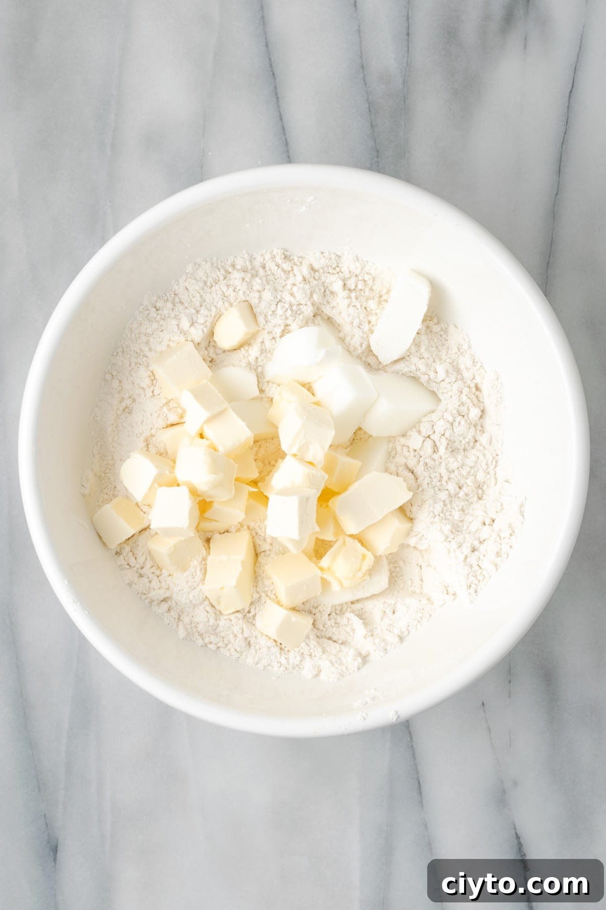 How to Make a Flaky Gluten-Free Pie Crust 9 Cubes of butter and shortening added to the mixing bowl with the dry ingredients.