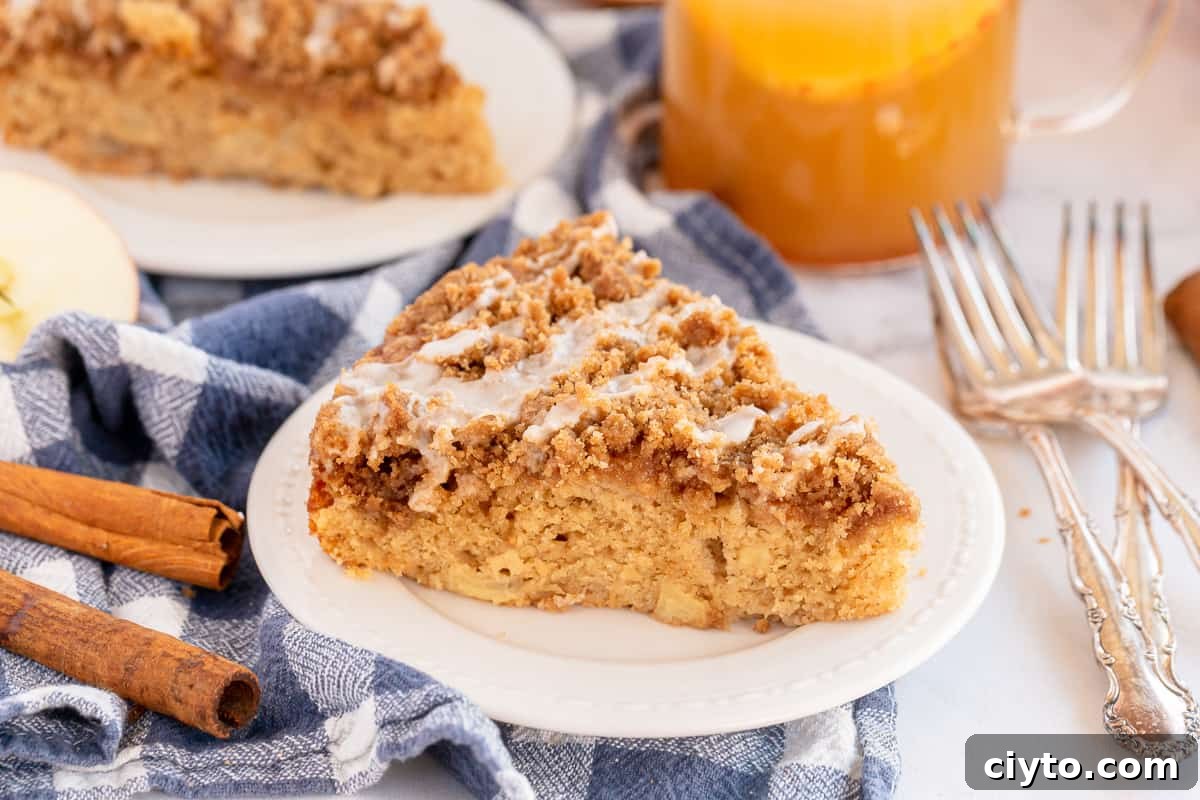 A slice of glazed coffee cake on a white plate.