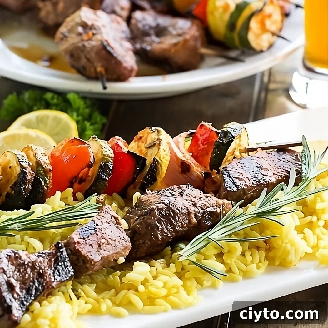 Juicy Grilled Beef Kabobs with Garlic Herb Marinade 2 Grilled Beef Kabobs over yellow rice.
