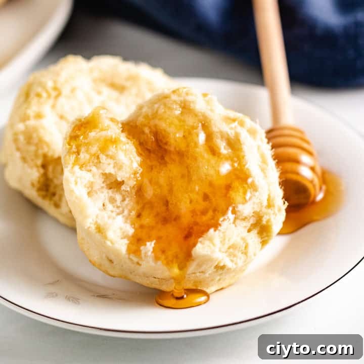 Half a sourdough biscuit topped with honey.